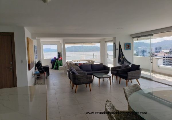 The kitchen and great room with floor to ceiling glass