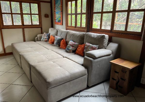 living room with large sectional with movable footrests