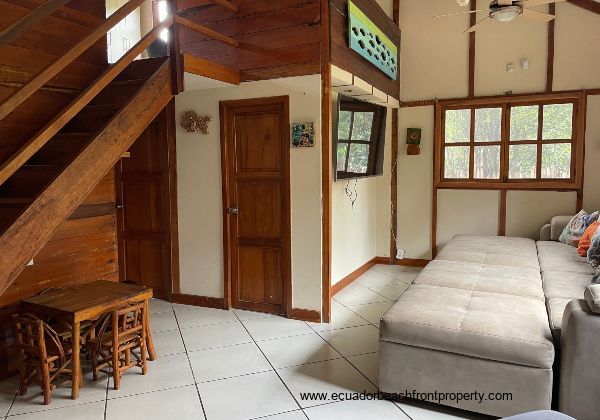 living room with door to full bathroom and laundry room