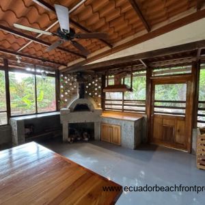 indoor patio with wood fired oven, counter prep space and hood vent 