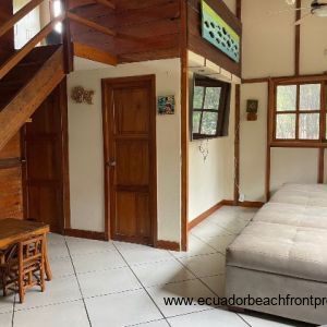 living room with door to full bathroom and laundry room