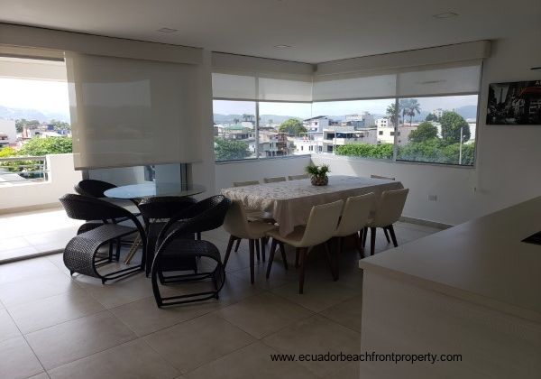 Dining area with balcony access and custom window covers