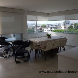 Dining area with balcony access and custom window covers