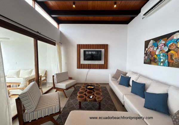 Living room opens to the oceanfront patio