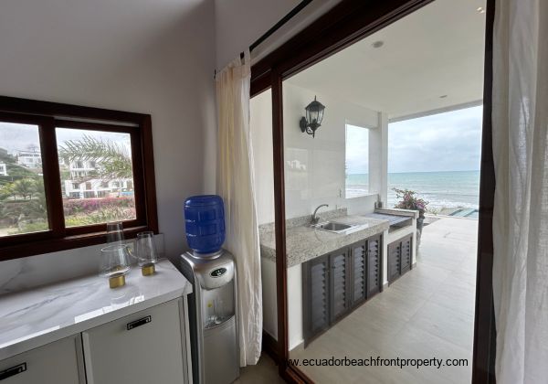 Kitchen opens to the living room and oceanfront patio