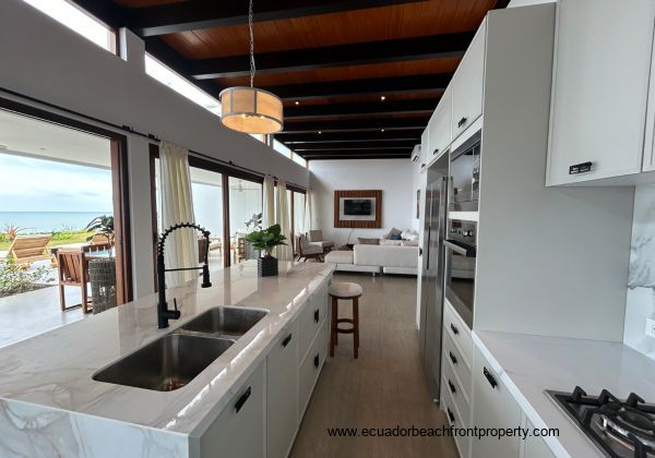 Kitchen opens to the living room and oceanfront patio