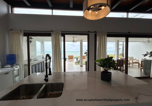 Kitchen opens to the living room and oceanfront patio