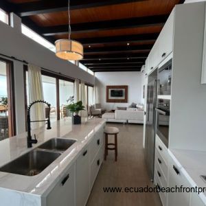 Kitchen opens to the living room and oceanfront patio