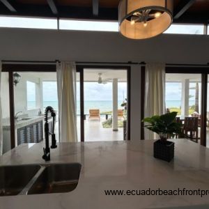 Kitchen opens to the living room and oceanfront patio