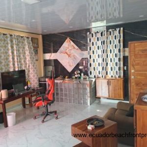 Guest suite is equipped with a single bed, futon sofa, desk, sink and small gas stove/oven